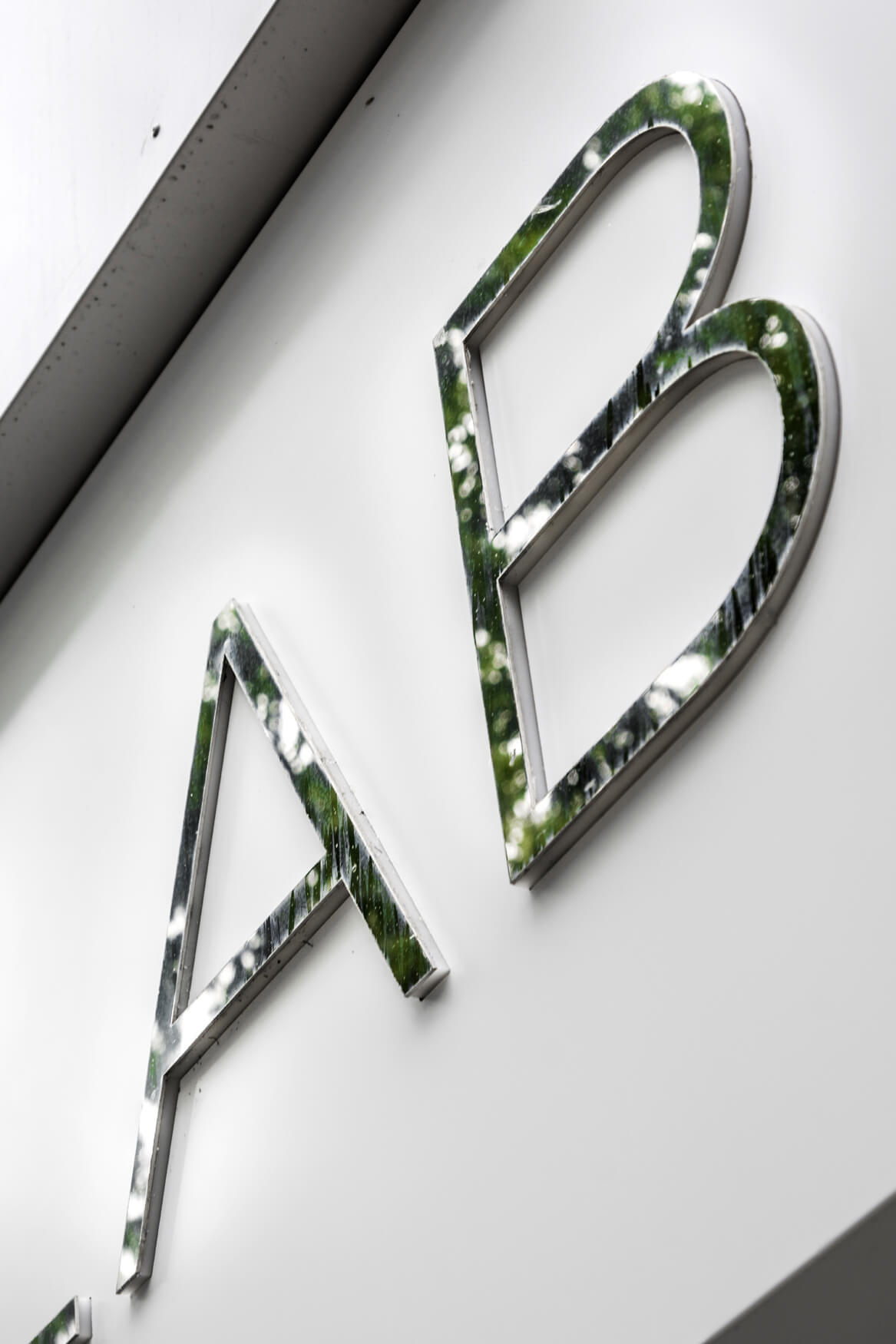 Premiumlab - a company sign placed on an advertising coffer with spatial letters made of sheet metal