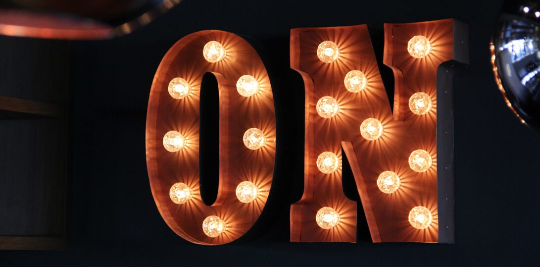 Letters filled with bulbs on a wall inside a building