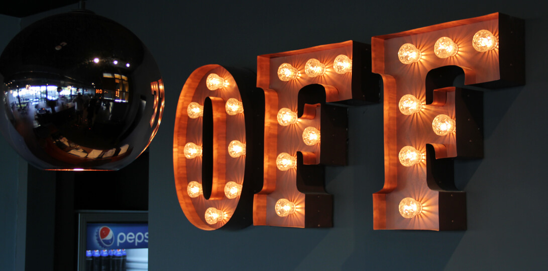 Letters filled with bulbs on the wall inside the building