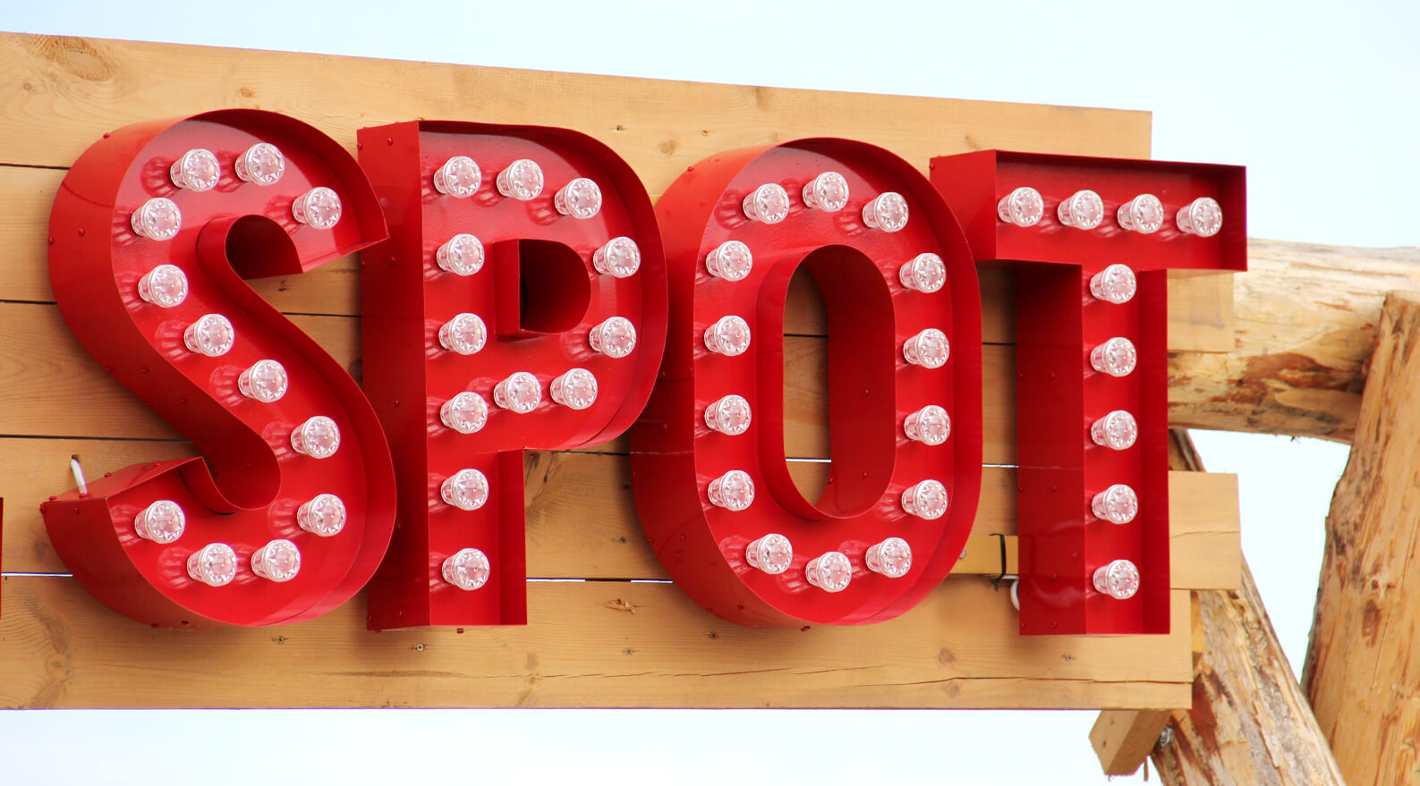 EB Hel Spot Festival - letters with light bulbs placed on a wooden frame above the entrance