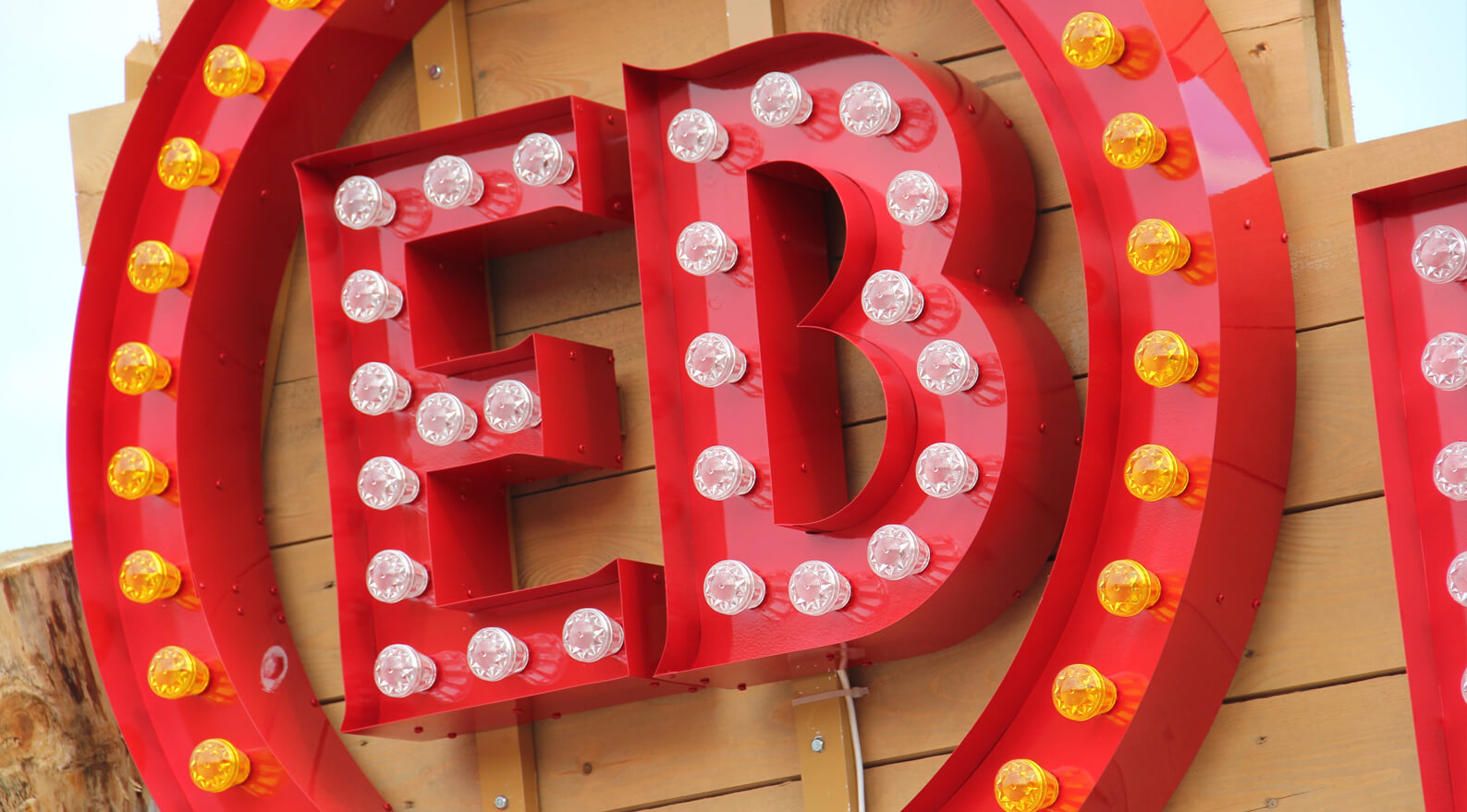 EB Hel Spot Festival - logo with light bulbs placed on a wooden frame above the entrance