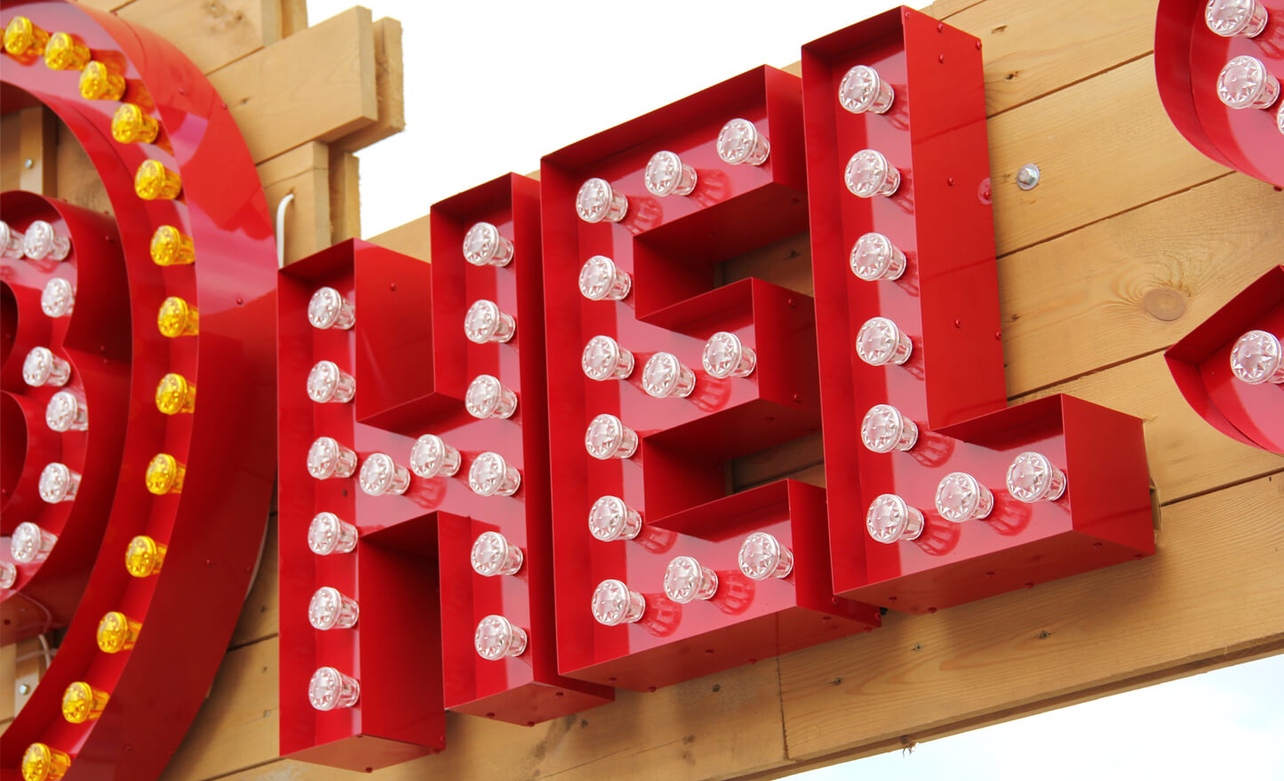 EB Hel Spot Festival - logo and letters with light bulbs placed on a wooden frame above the entrance