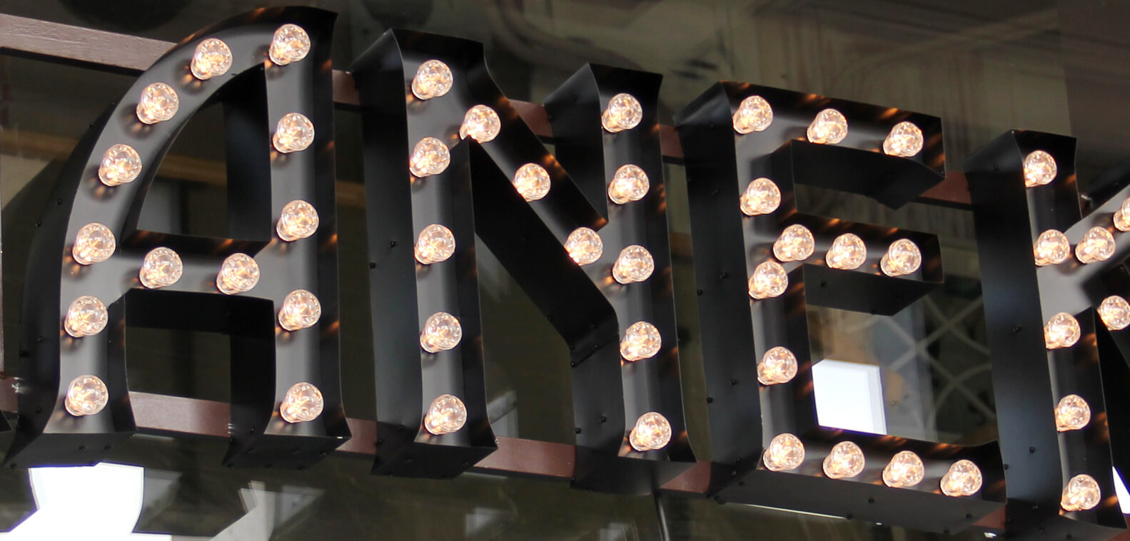 Mannequin - letters with bulbs placed on the rack over the entrance