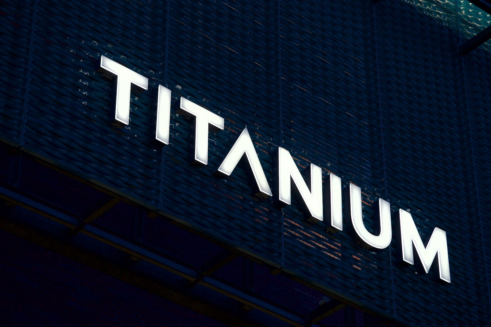 Titanium - spatial lettering glowing above the entrance