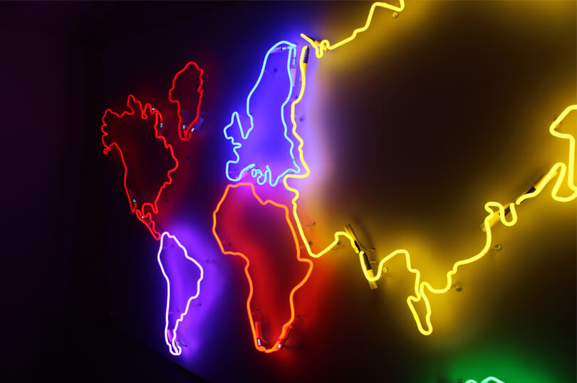 Map of the world created as a neon sign, placed on the wall inside the premises