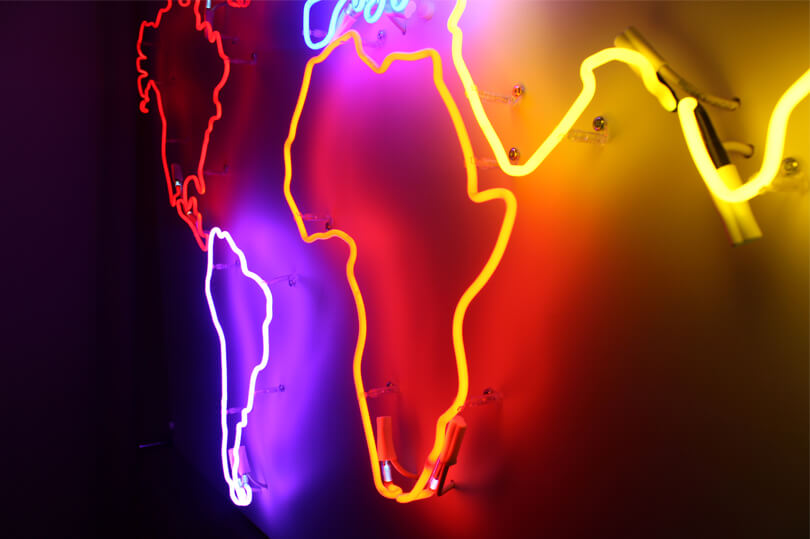 Map of the world created as a neon sign, placed on the wall inside the premises