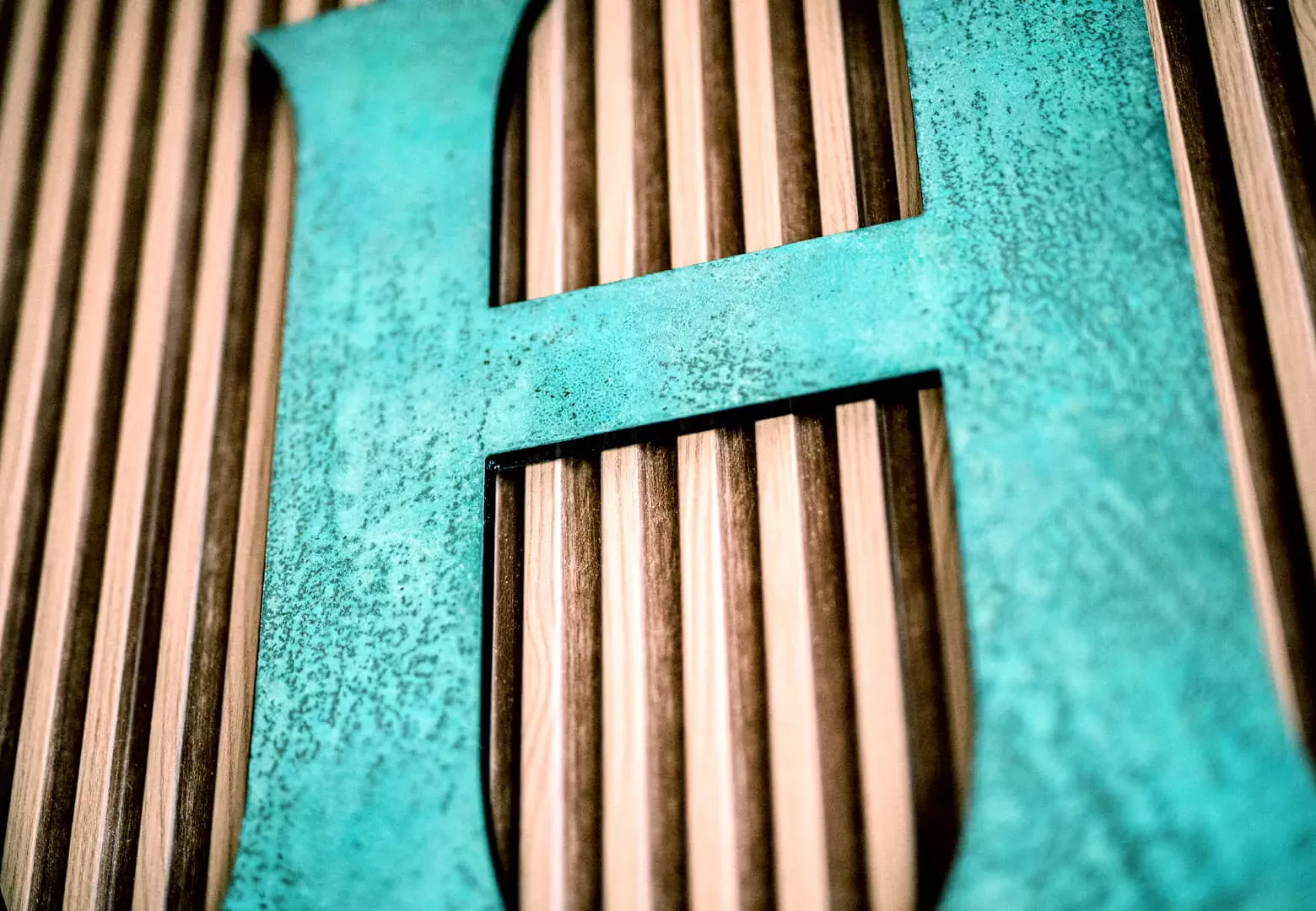 Litera H - wykonana z metalu w stylu industrialnym, pokryta patyną