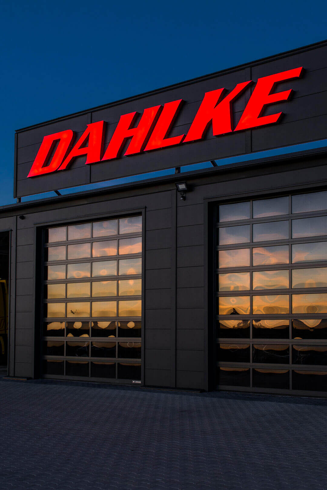 dahlke dalke roadside assistance - dahlke-marek road assistance-lipinki-noble-bypass-light-letters-on-the-building-red-inscription-over-the-entrance-large-letters-on-the-wall-on-outside-letters-over-the-gate-entrance-yellow- backlit