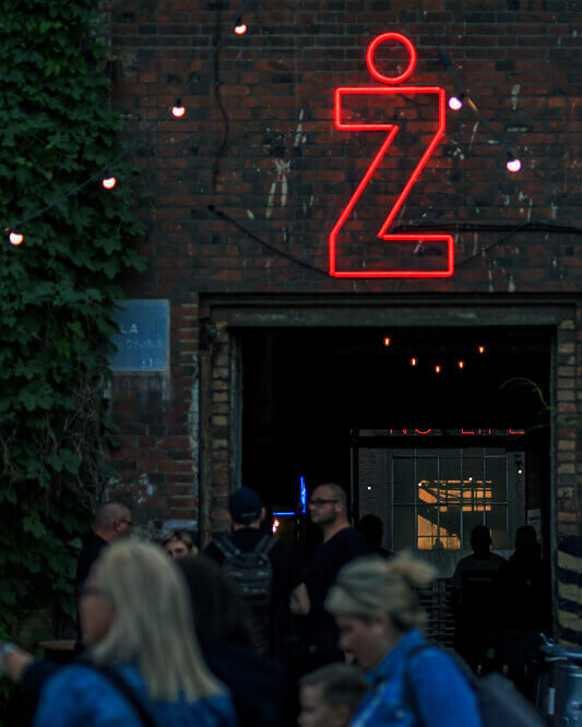 One wants to ¿ - Neon sign Zwyiec, Zwyiec company, on a metal grid.