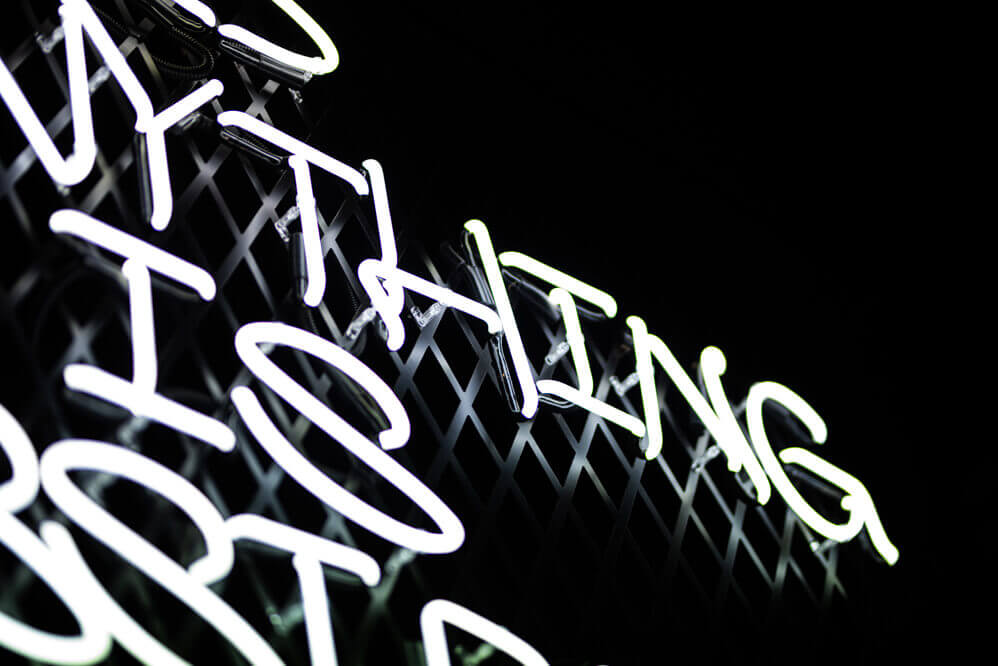 Hennything is possible - Neon sign advertising on the wire mesh above the bar in Gdańsk.