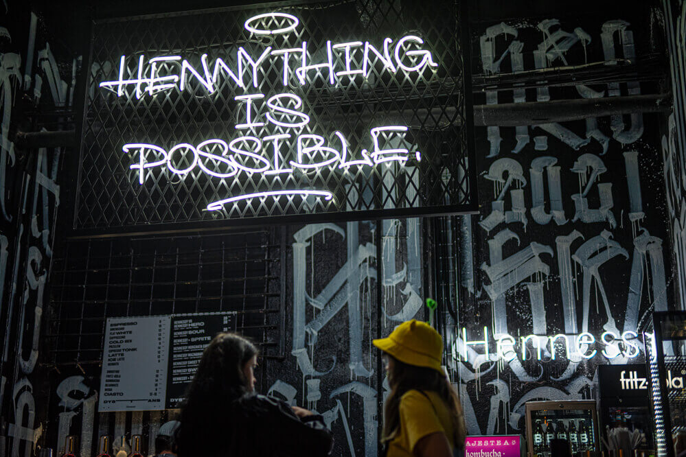Hennything is possible - Neon sign advertising on the wire mesh over the bar in Gdańsk.