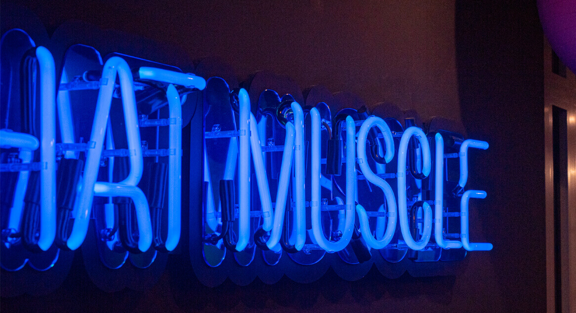 Hustle for that muscle - blue neon on wall