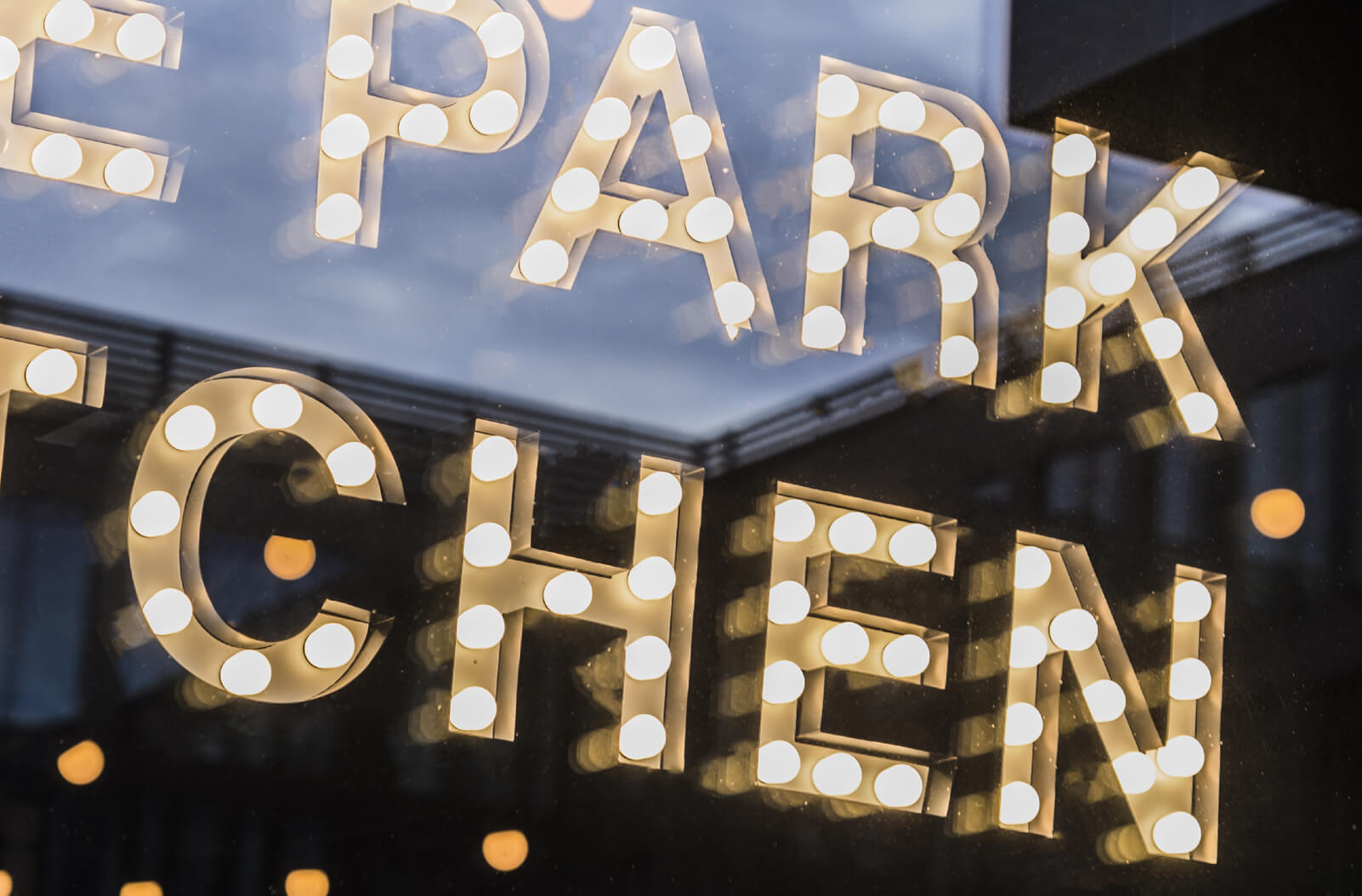 Die Park-Küche - The Park Kitchen - kleine Buchstaben mit Glühbirnen hinter dem Glas