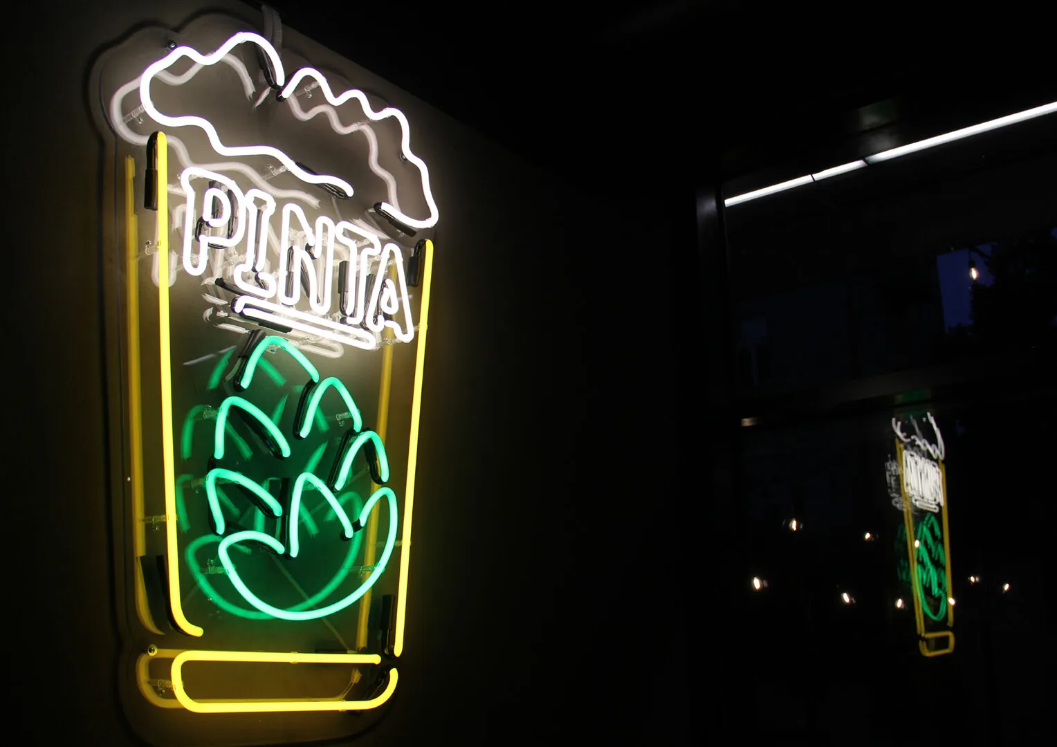 Pinta - Leuchtreklame in Form eines Glases mit einer Aufschrift
