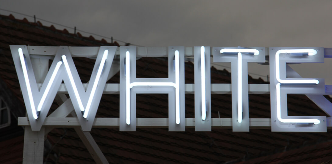 Weißer Marlin - White Marlin - Leuchtreklame auf einem Rahmen, auf dem Dach des Gebäudes