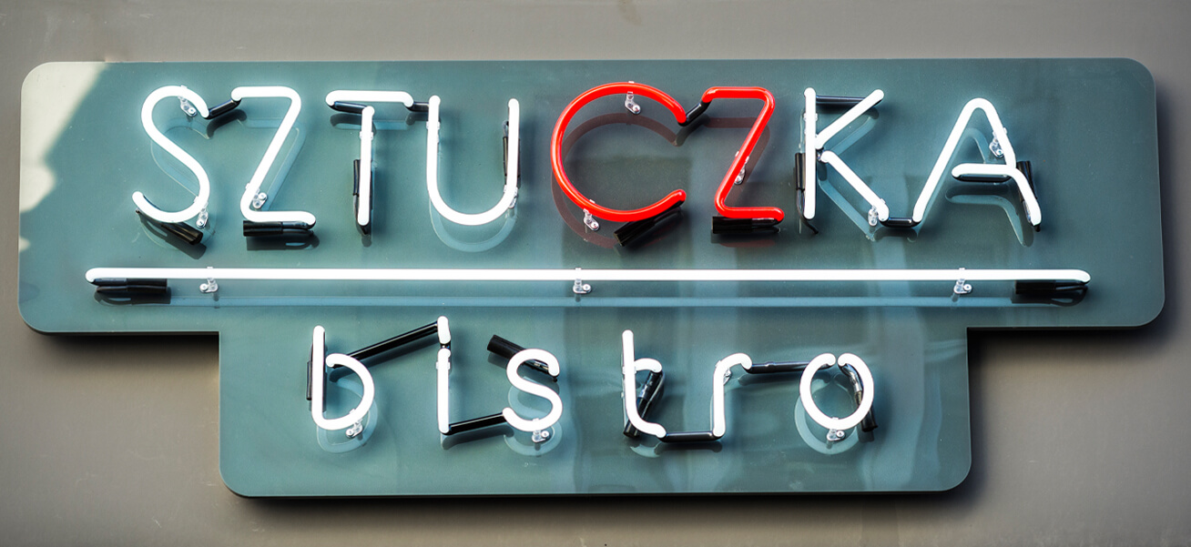 Trick Bistro - Sztuczka Bistro - advertising neon sign, mounted on plexiglass, placed above the entrance