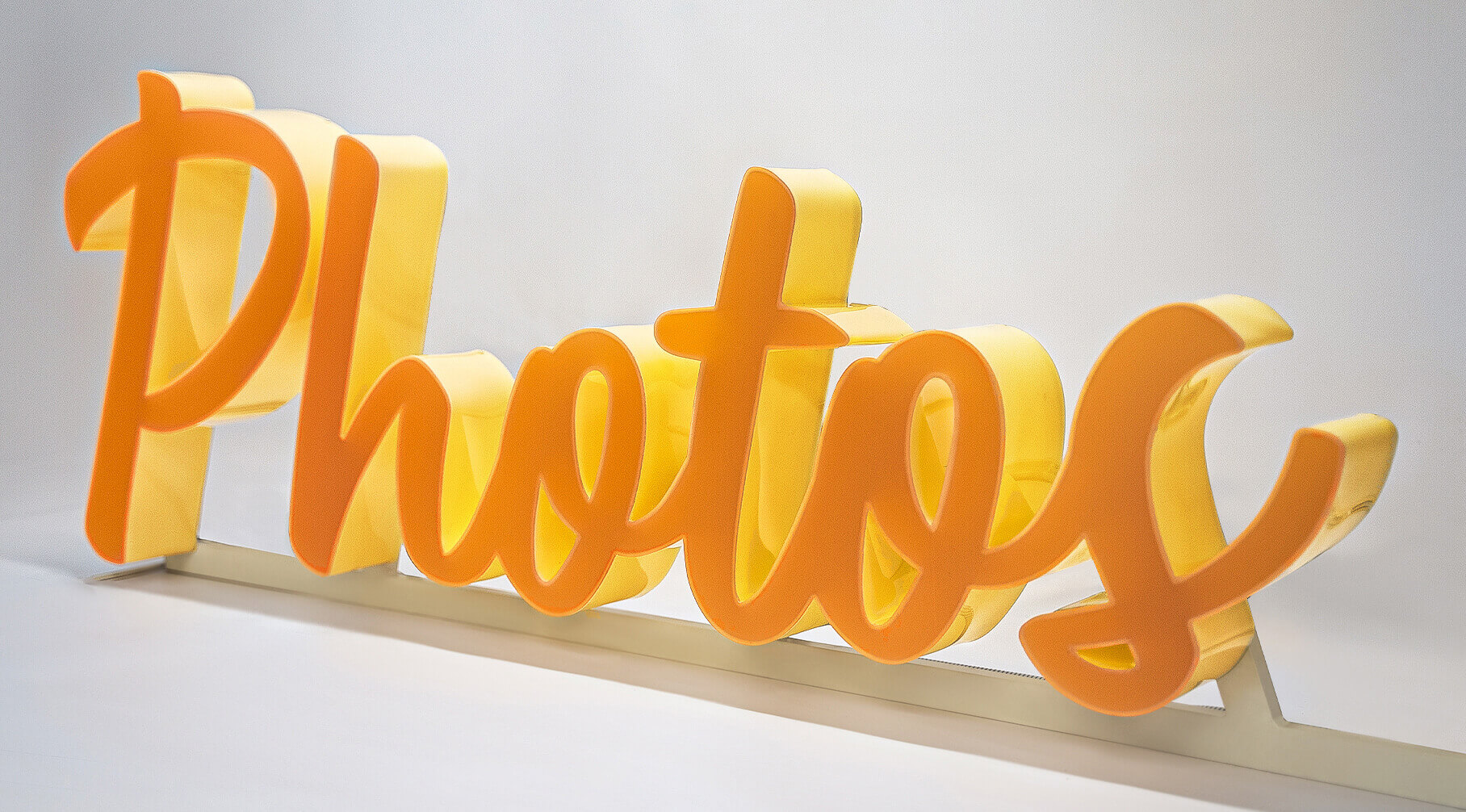 Photos - Lettres en plexiglas brillantes sur le devant et sur le côté, en orange.