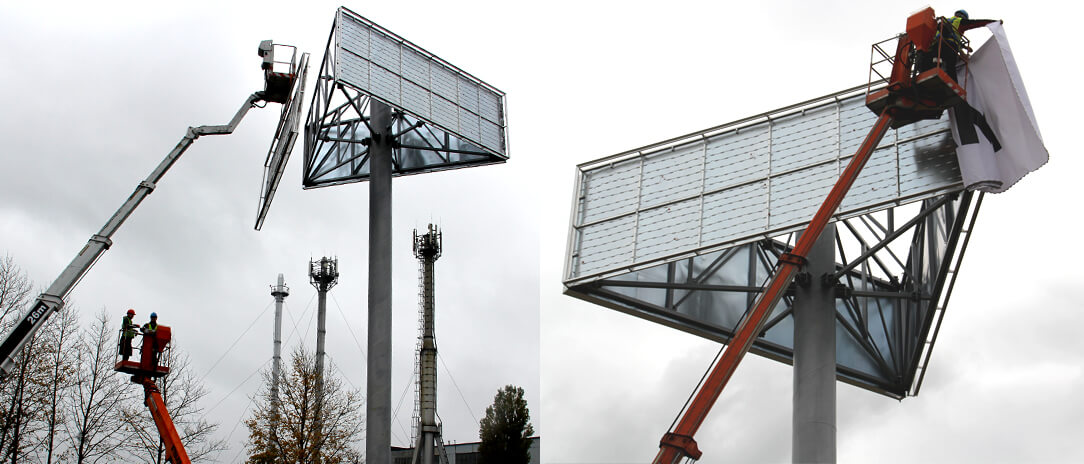 ULMA - Scatole luminose di grande formato - ULMA - montaggio di un pannello di grande formato su una torre pubblicitaria